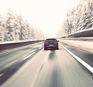 Car driving fast in snow